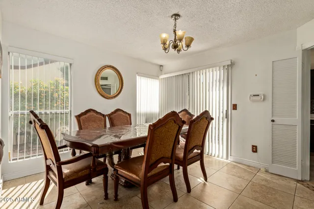 a view of a dining room with furniture and chandelier