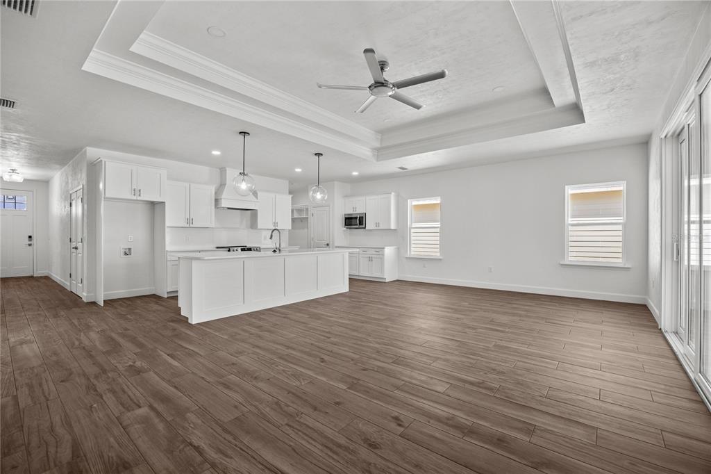 1132 Southwest 67th Drive Gainesville, FL 32607 - Photo 17 of 30 a view of a kitchen with wooden floor and a kitchen