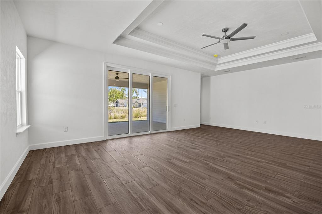1132 Southwest 67th Drive Gainesville, FL 32607 - Photo 19 of 30 a view of empty room with wooden floor and fan