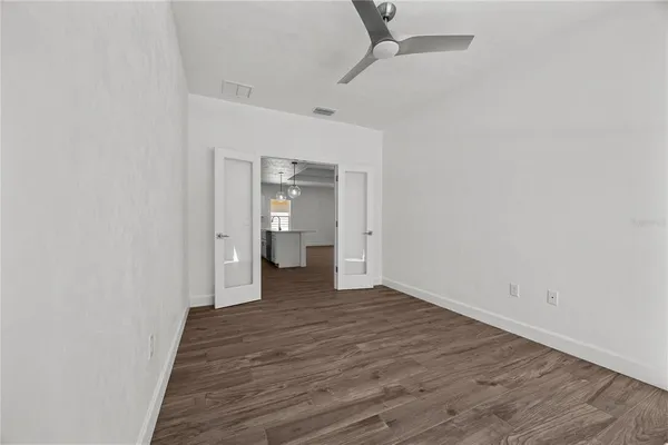 a view of a room with wooden floor and bathroom