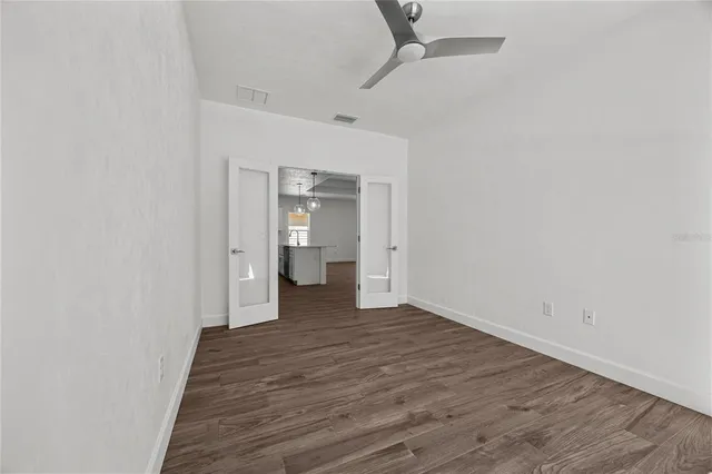 a view of a room with wooden floor and bathroom