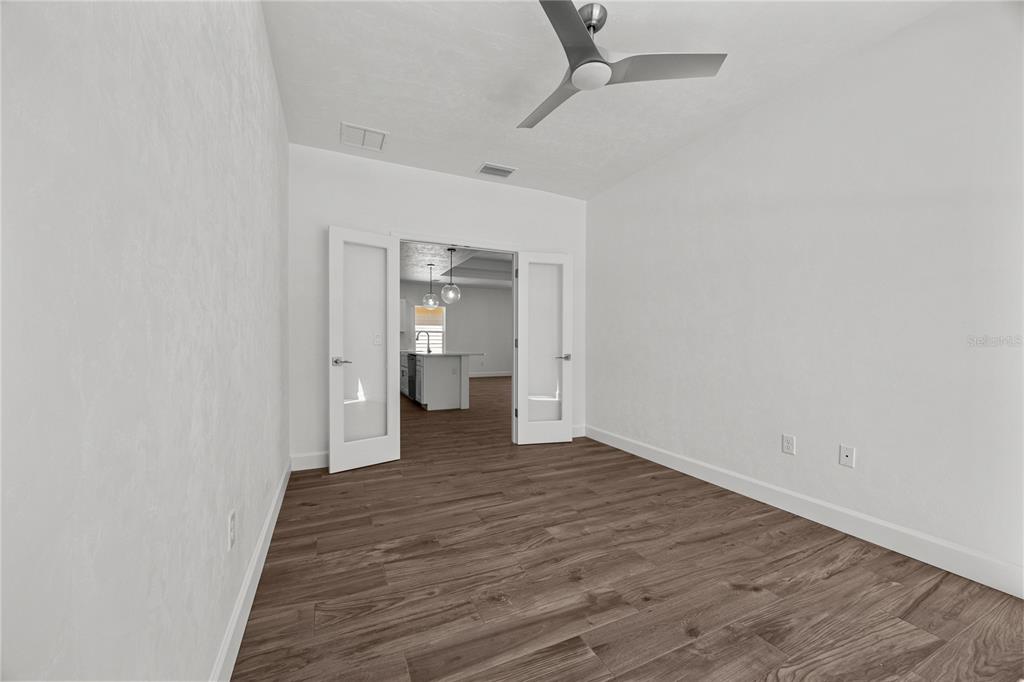 1132 Southwest 67th Drive Gainesville, FL 32607 - Photo 20 of 30 a view of a room with wooden floor and bathroom