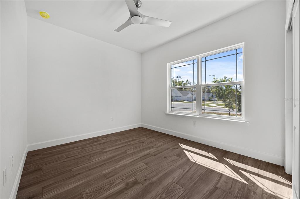 1132 Southwest 67th Drive Gainesville, FL 32607 - Photo 21 of 30 a view of an empty room with wooden floor and a window