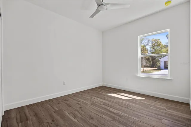 wooden floor in an empty room with a window