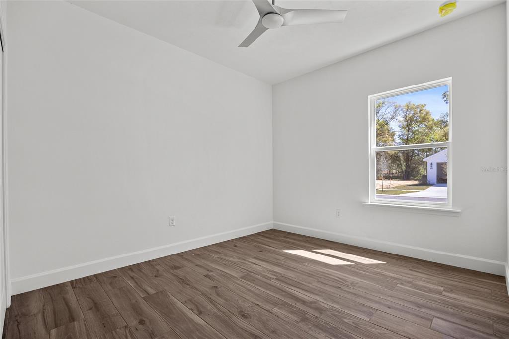 1132 Southwest 67th Drive Gainesville, FL 32607 - Photo 23 of 30 wooden floor in an empty room with a window