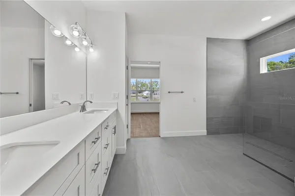 a bathroom with a double vanity sink and a mirror