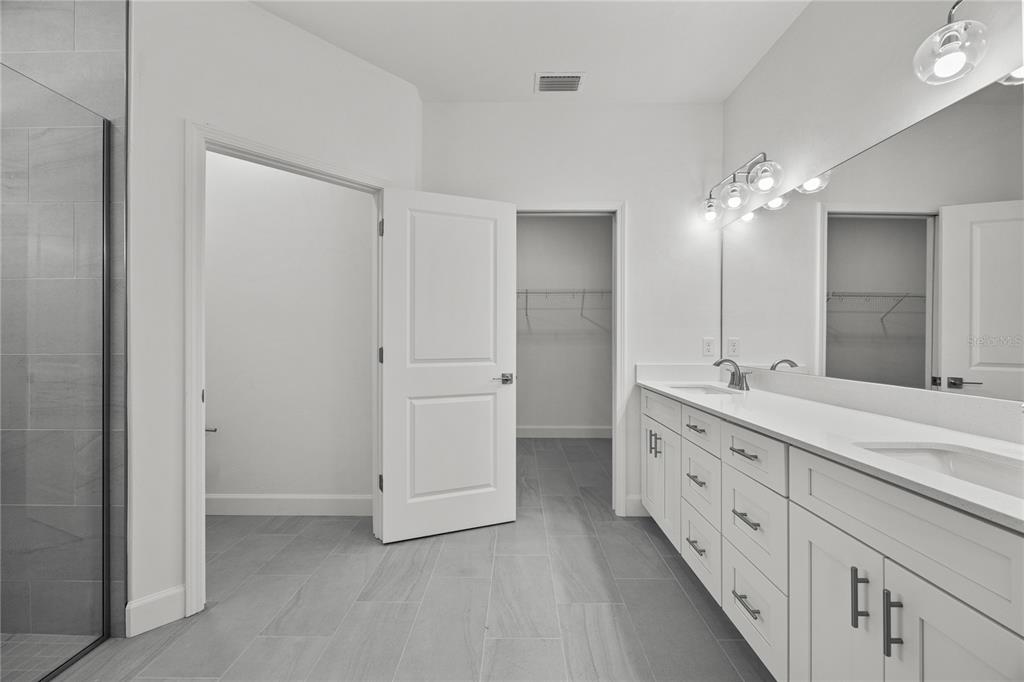 1132 Southwest 67th Drive Gainesville, FL 32607 - Photo 9 of 30 a bathroom with double vanity sink and a mirror
