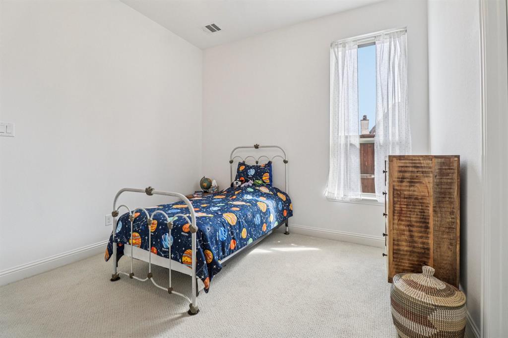 8277 Halifax The Colony, TX 75056 - Photo 26 of 37 a bedroom with a bed and a window
