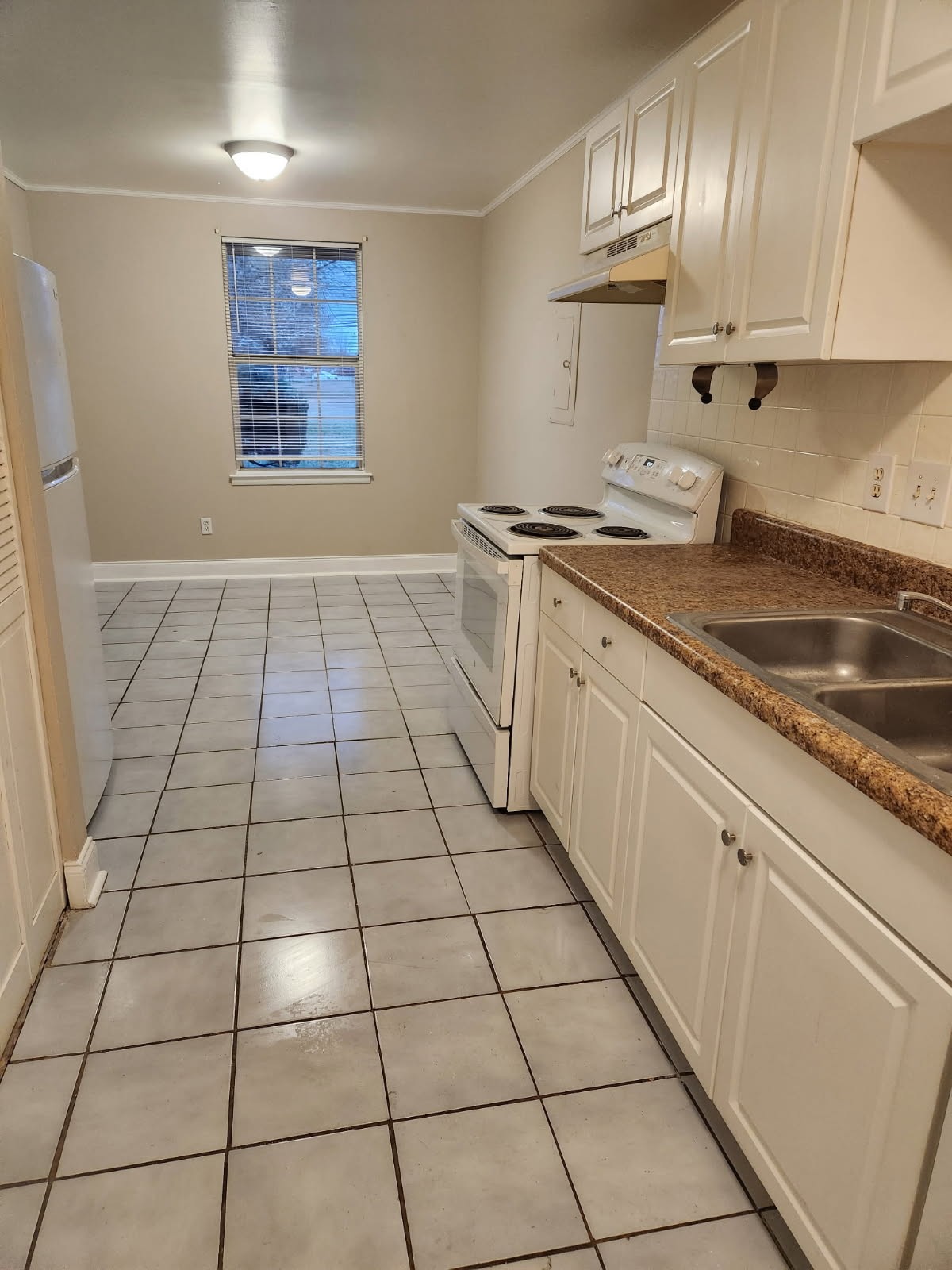 1301 Neelys Bend Road, Unit A2 Madison, TN 37115 - Photo 4 of 9 a kitchen with a sink a stove cabinets and counter space