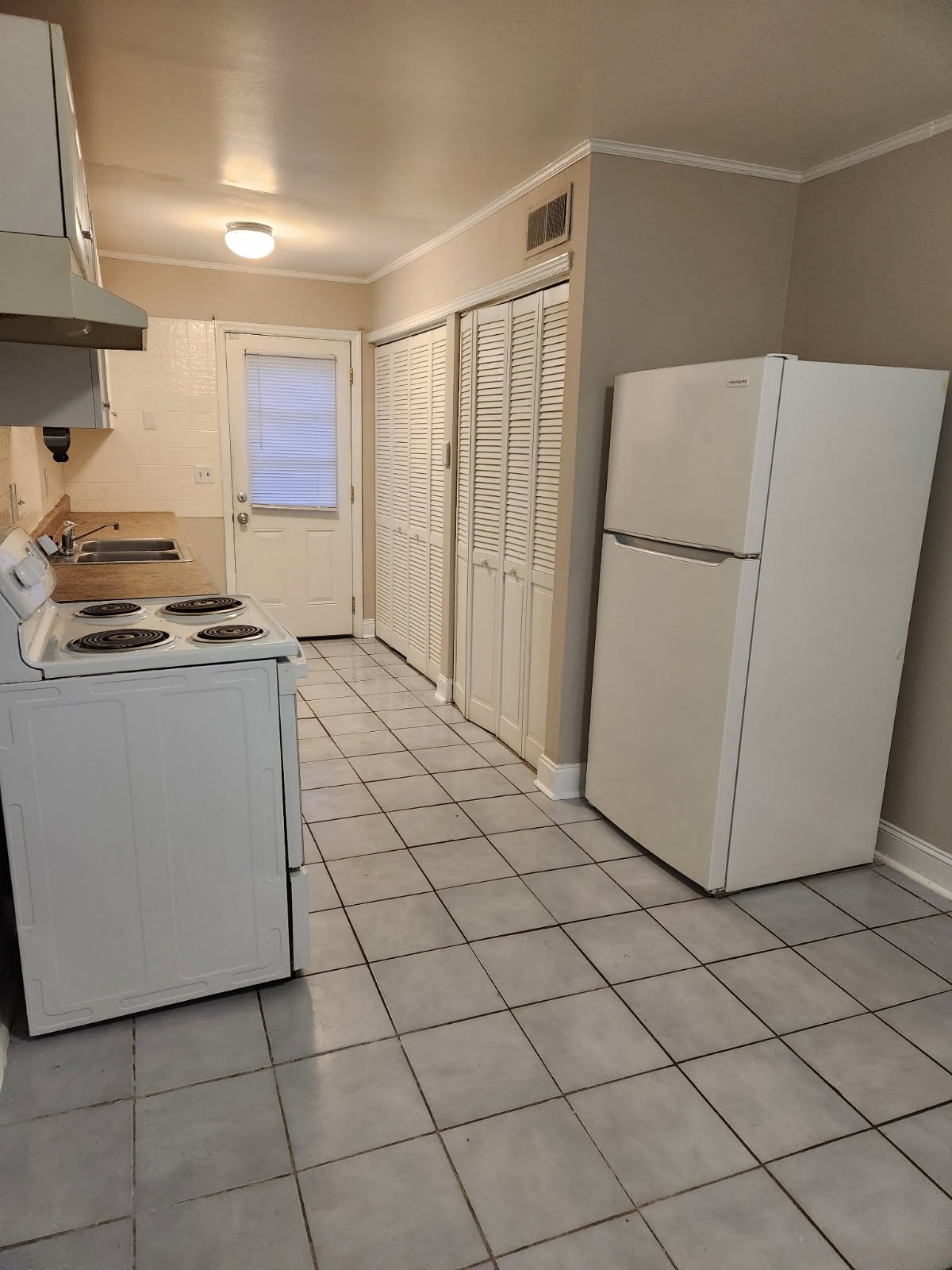 1301 Neelys Bend Road, Unit A2 Madison, TN 37115 - Photo 5 of 9 a kitchen with a white cabinets and white appliances