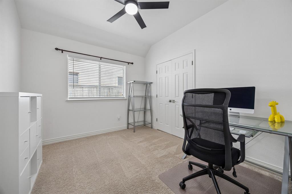 9217 Inverness Drive Rowlett, TX 75089 - Photo 25 of 40 Flexible Bedroom or Work Space — With natural light, closet storage, and an updated ceiling fan, this room easily adapts for sleeping, working, creating, or organizing.
