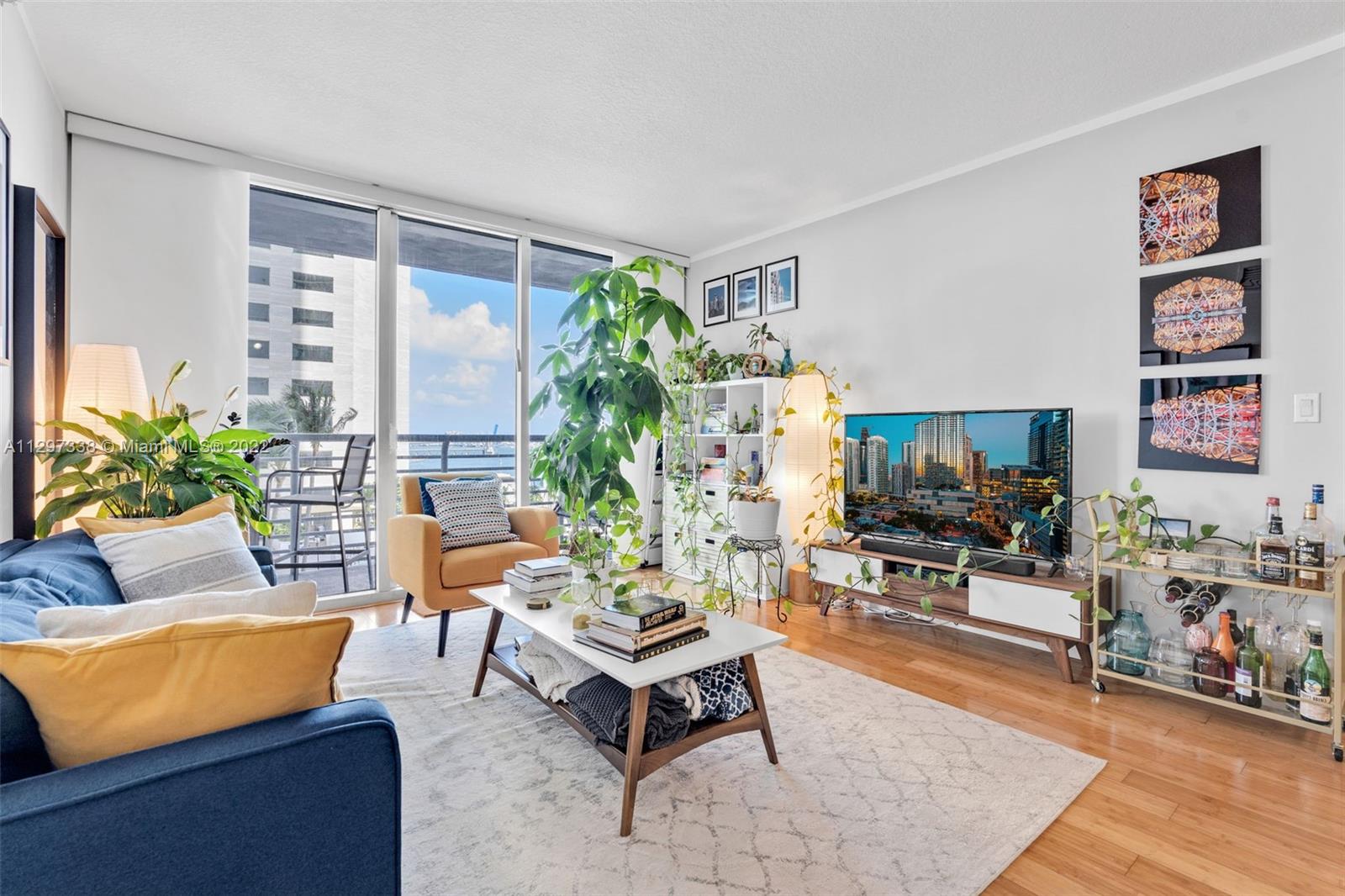 Downtown Miami Miami, FL 33131 - Photo 11 of 30 a living room with furniture potted plant and a large window