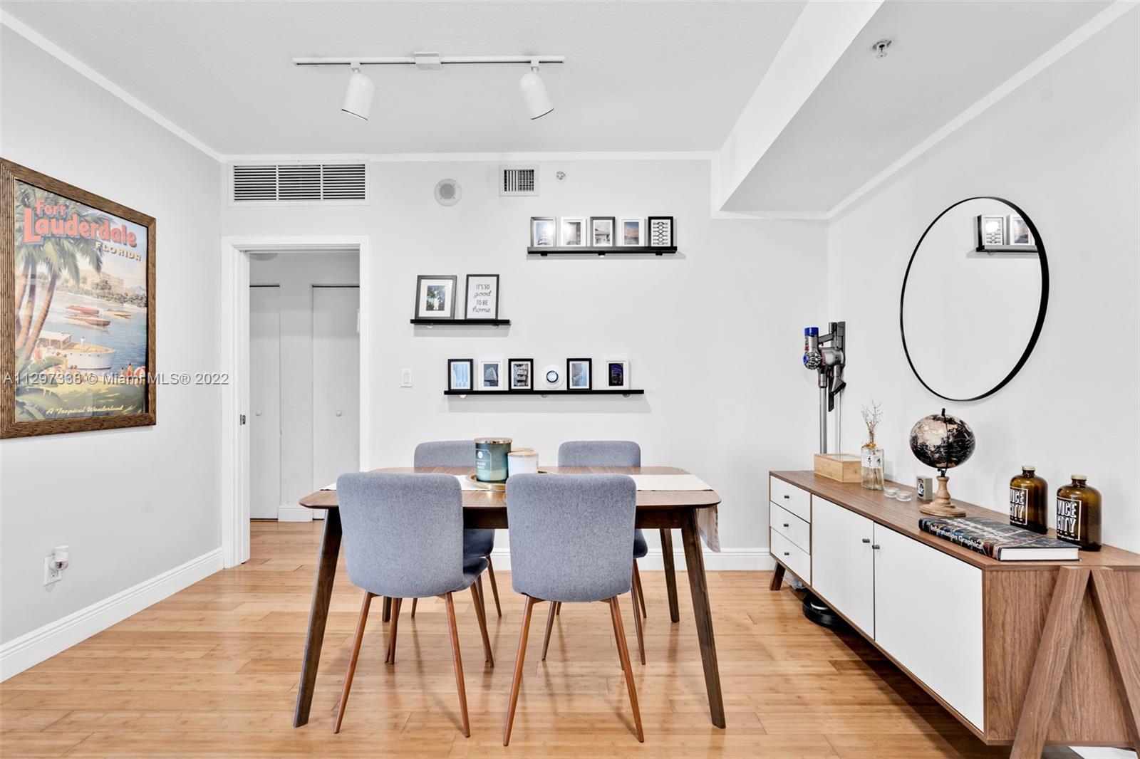 Downtown Miami Miami, FL 33131 - Photo 13 of 30 a view of a dining room with furniture and a mirror