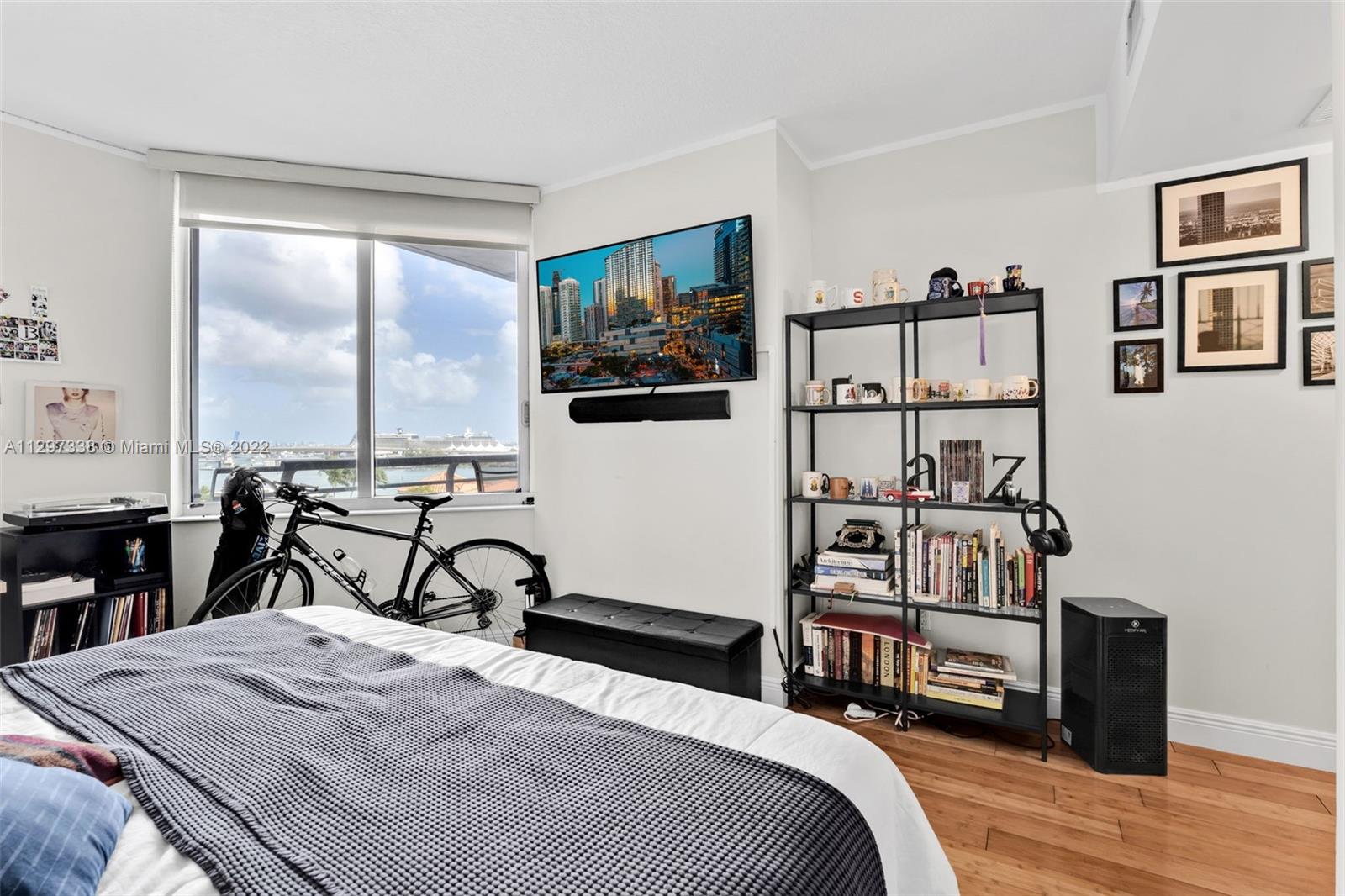 Downtown Miami Miami, FL 33131 - Photo 18 of 30 a bedroom with a bed a computer on table and a large window