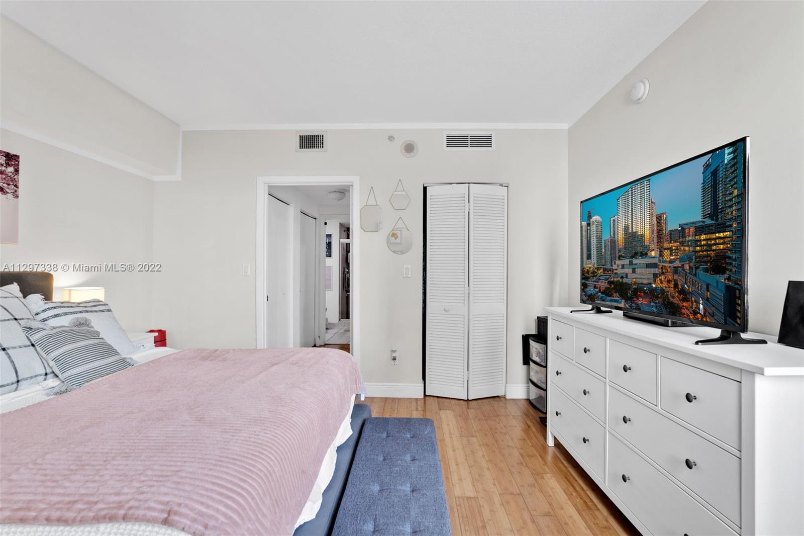 Downtown Miami Miami, FL 33131 - Photo 20 of 30 a bedroom with a bed and a flat screen tv