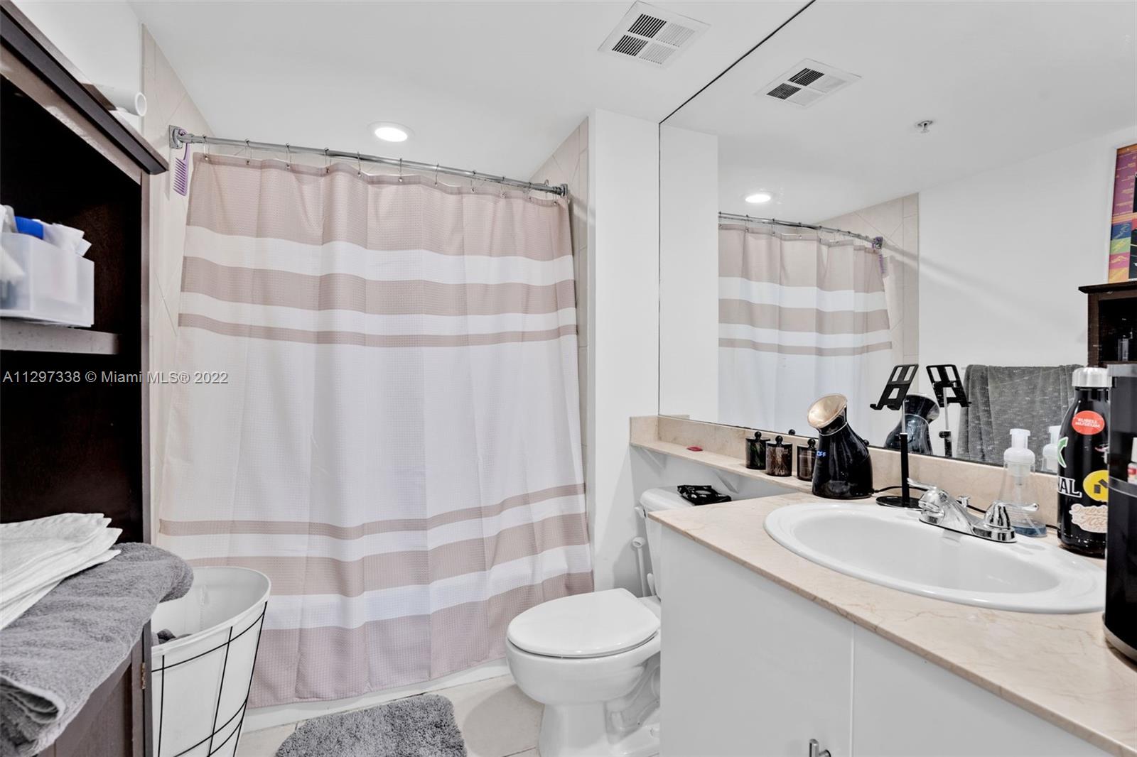 Downtown Miami Miami, FL 33131 - Photo 23 of 30 a bathroom with a sink toilet and shower