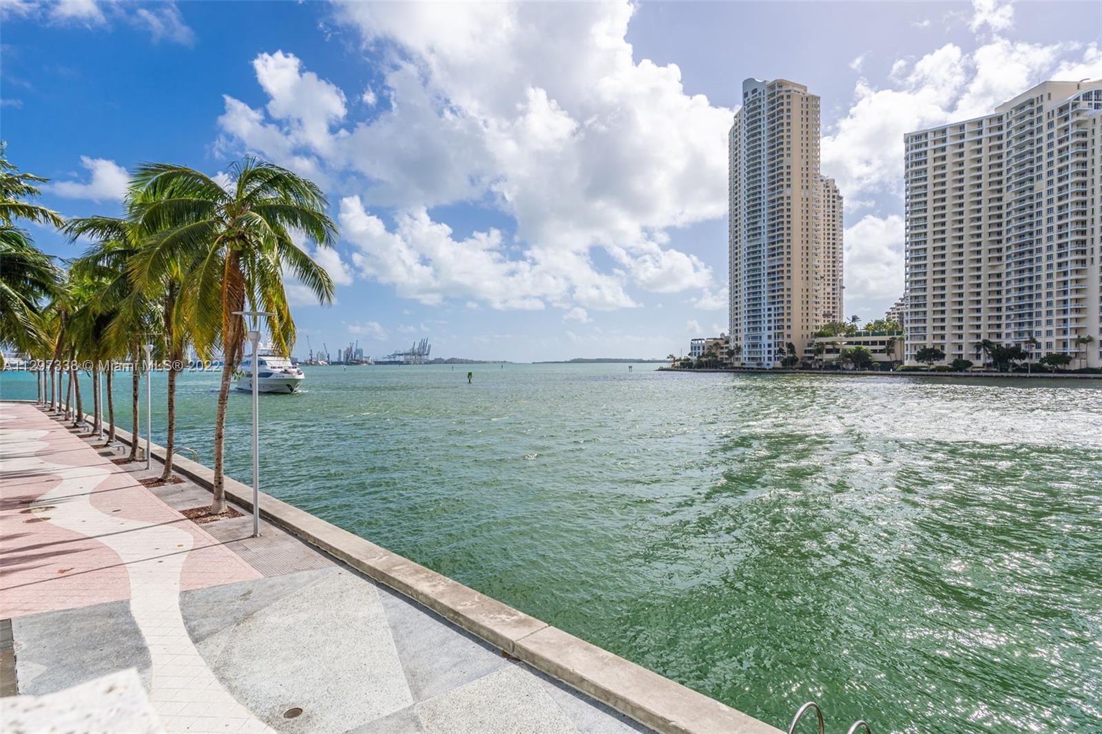 Downtown Miami Miami, FL 33131 - Photo 3 of 30 a view of a lake with a large building in the background