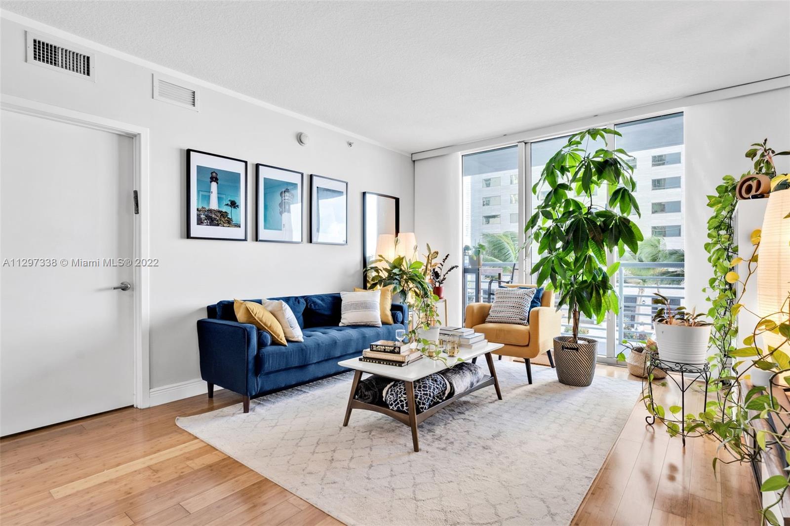 Downtown Miami Miami, FL 33131 - Photo 6 of 30 a living room with furniture and a potted plant