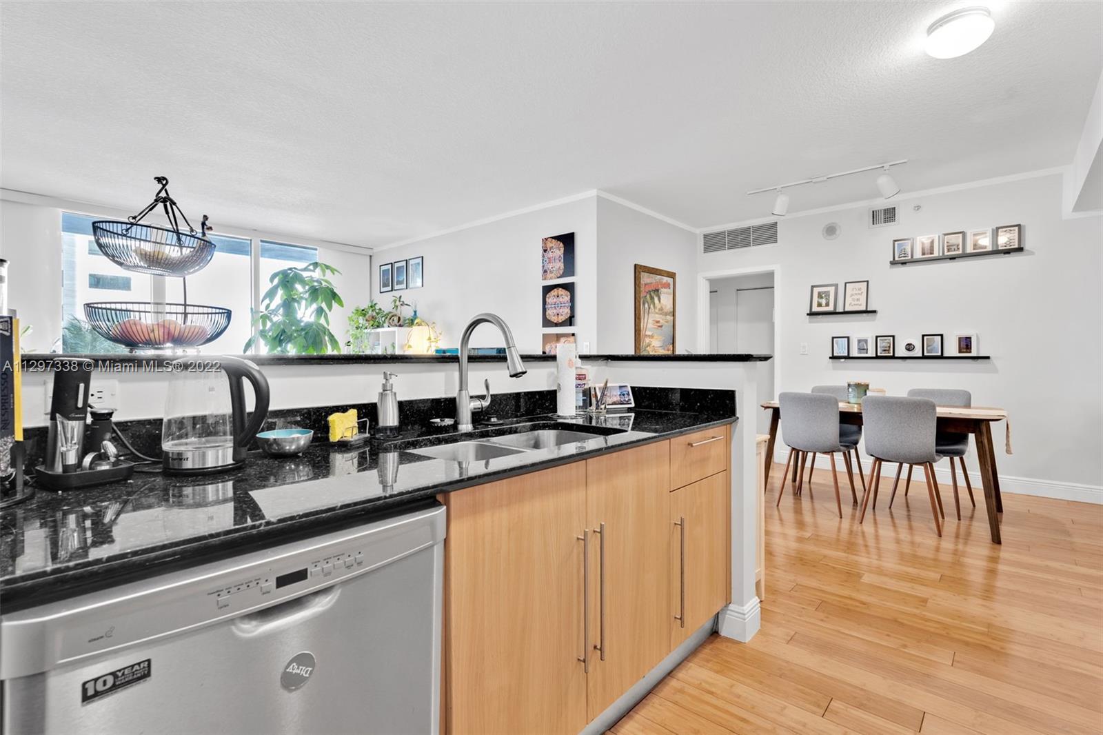 Downtown Miami Miami, FL 33131 - Photo 8 of 30 a kitchen with stainless steel appliances granite countertop a sink and cabinets