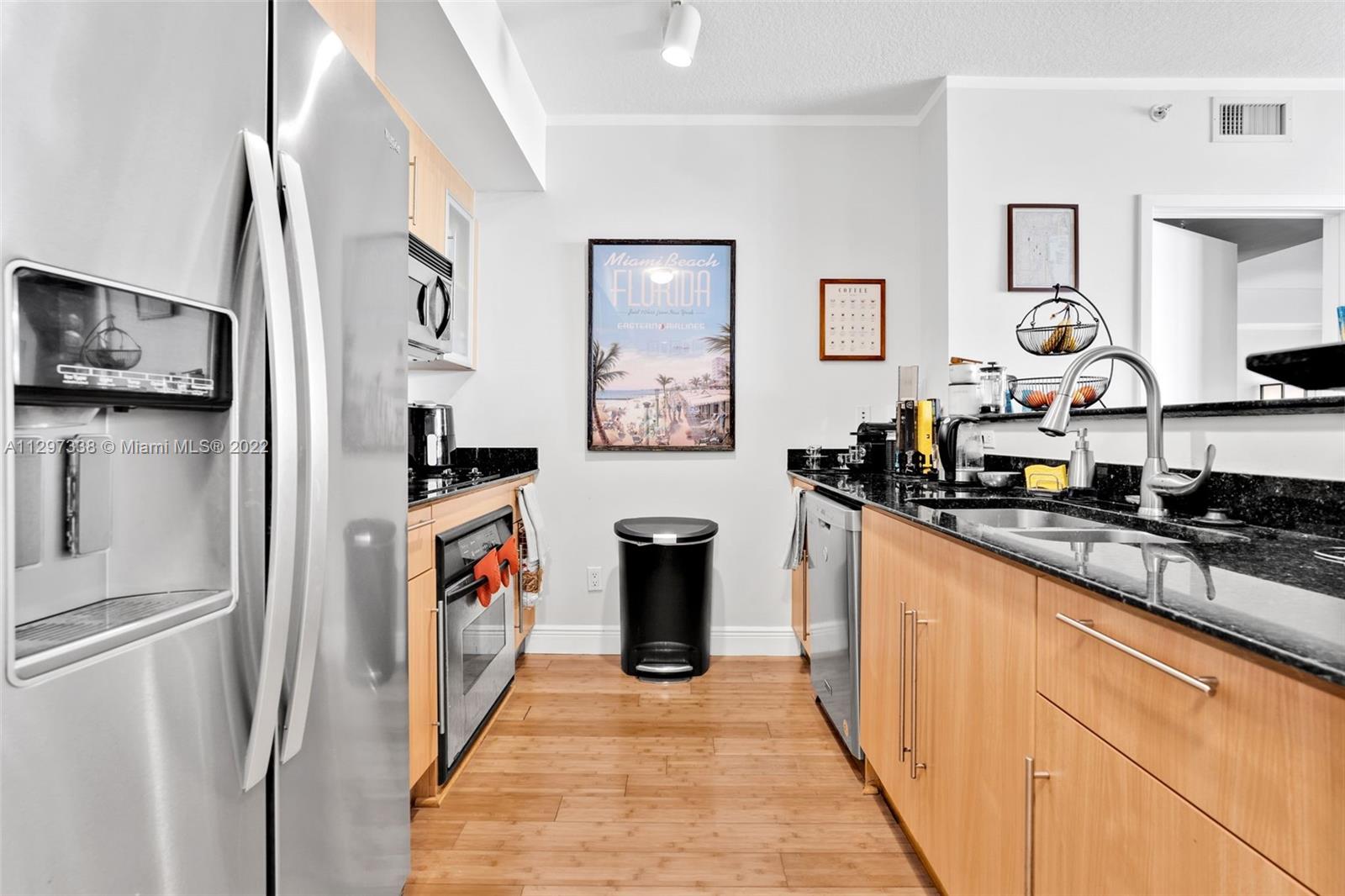 Downtown Miami Miami, FL 33131 - Photo 9 of 30 a kitchen with stainless steel appliances granite countertop a refrigerator and a stove top oven