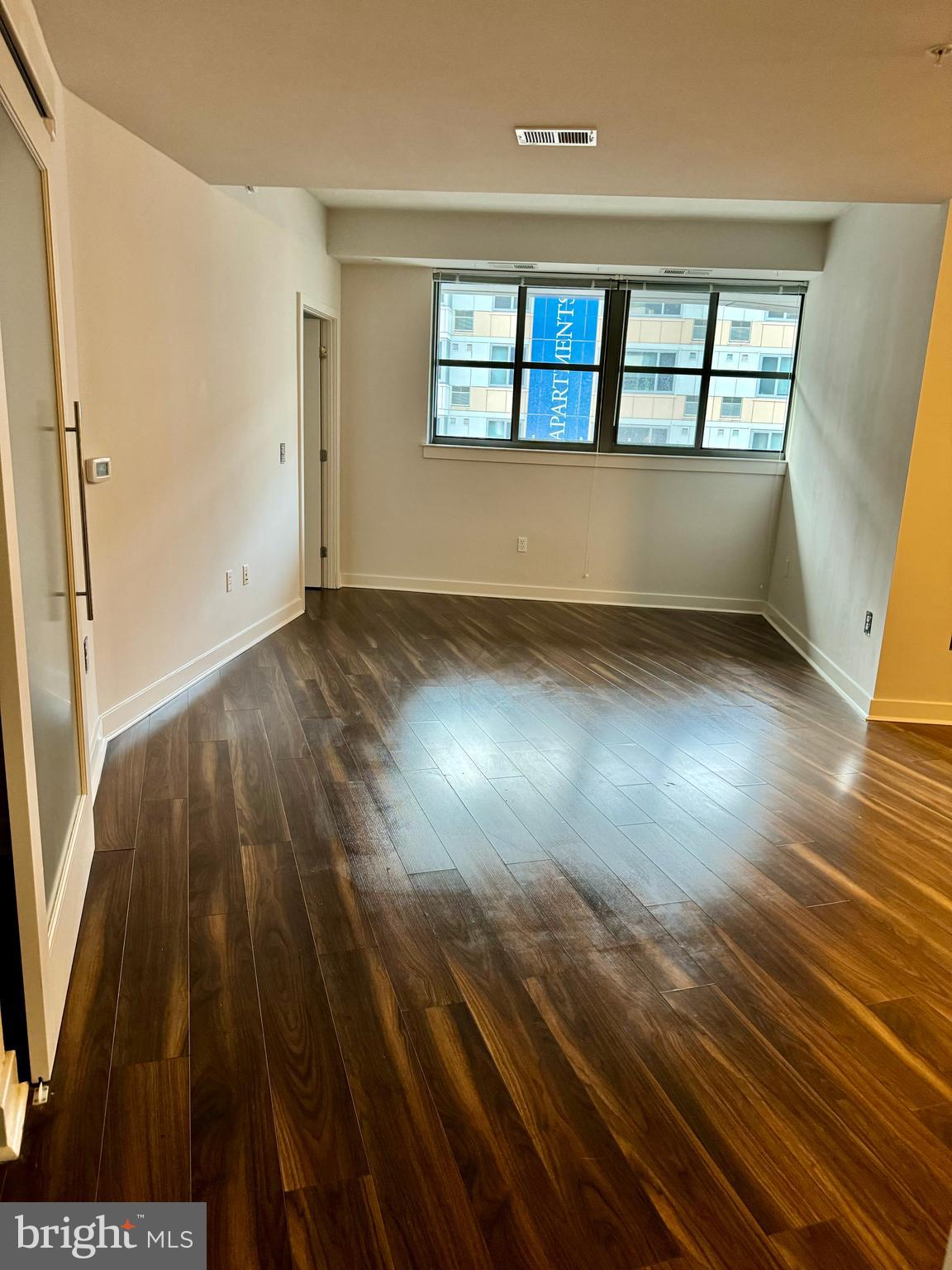 460 New York Avenue Northwest, Unit 407 Washington, DC 20001 - Photo 35 of 64 wooden floor in an empty room with a window
