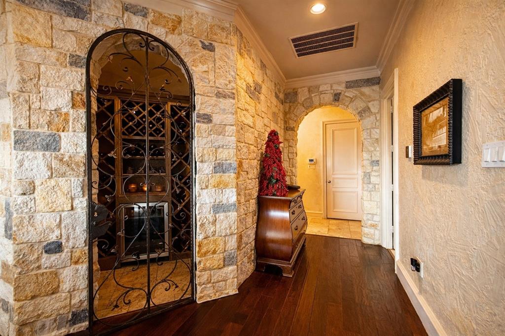 1919 Kings Pass Heath, TX 75032 - Photo 15 of 38 This hallway features rich hardwood flooring and stone wall accents