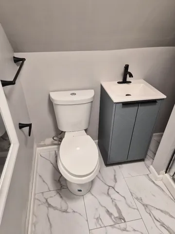 a bathroom with a toilet and a sink