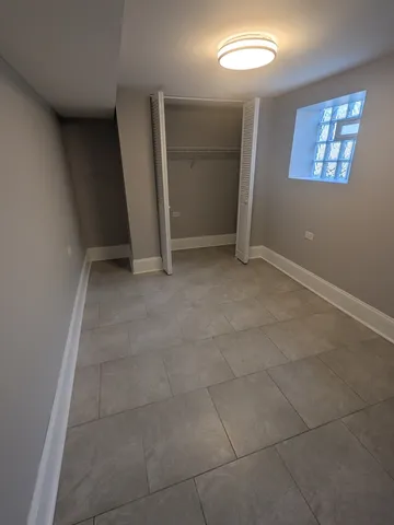 an empty room with windows and entrance