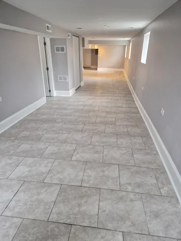 a view of an empty room and a window