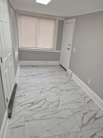 a view of a room with white walls