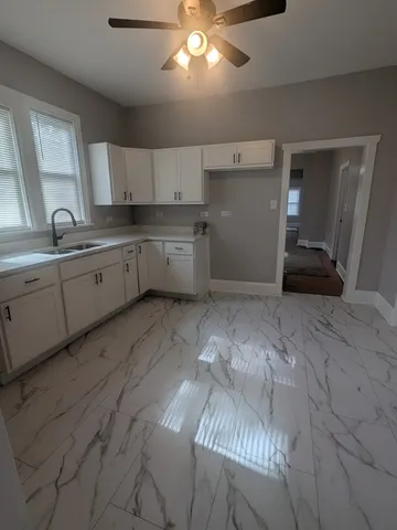 a large white kitchen with cabinets