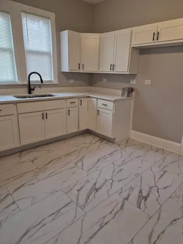 a kitchen with a sink and cabinets