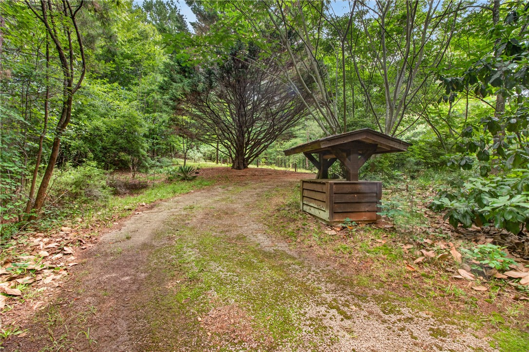 130 Maggie Rufus Lane Westminster, SC 29693 - Photo 34 of 50 A secluded wooded lot offers ample privacy and connection with nature, featuring a charming wishing well.