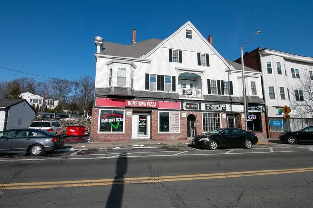 a view of a street that has couple of cars parked on the road