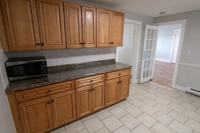a kitchen with stainless steel appliances granite countertop a sink and cabinets