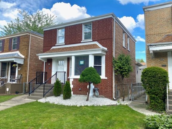 9405 South Laflin Street Chicago, IL 60620 - Photo 1 of 24 a view of a house with a yard and plants