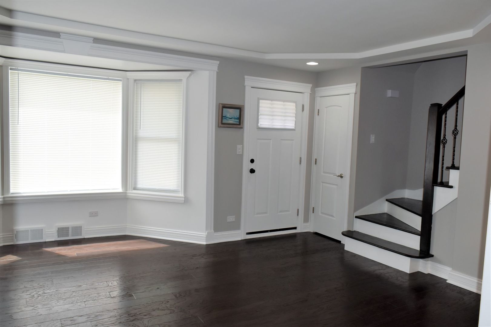 9405 South Laflin Street Chicago, IL 60620 - Photo 2 of 24 a view of an empty room with wooden floor and a window