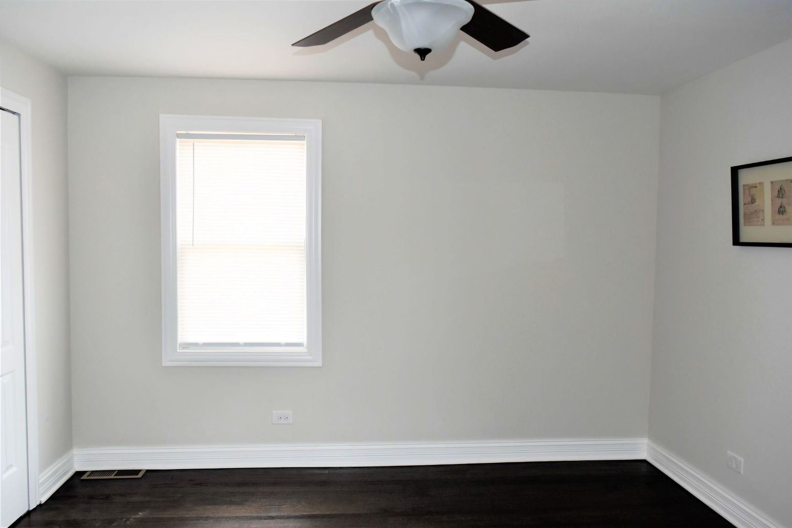9405 South Laflin Street Chicago, IL 60620 - Photo 11 of 24 an empty room with wooden floor and windows