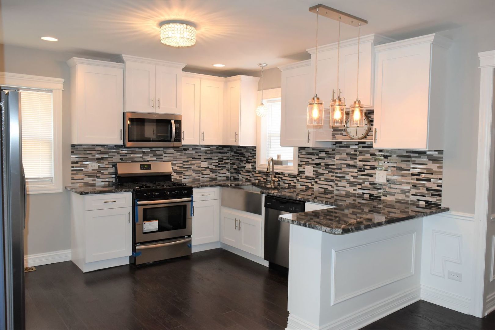 9405 South Laflin Street Chicago, IL 60620 - Photo 6 of 24 a kitchen with stainless steel appliances kitchen island granite countertop a stove and a sink