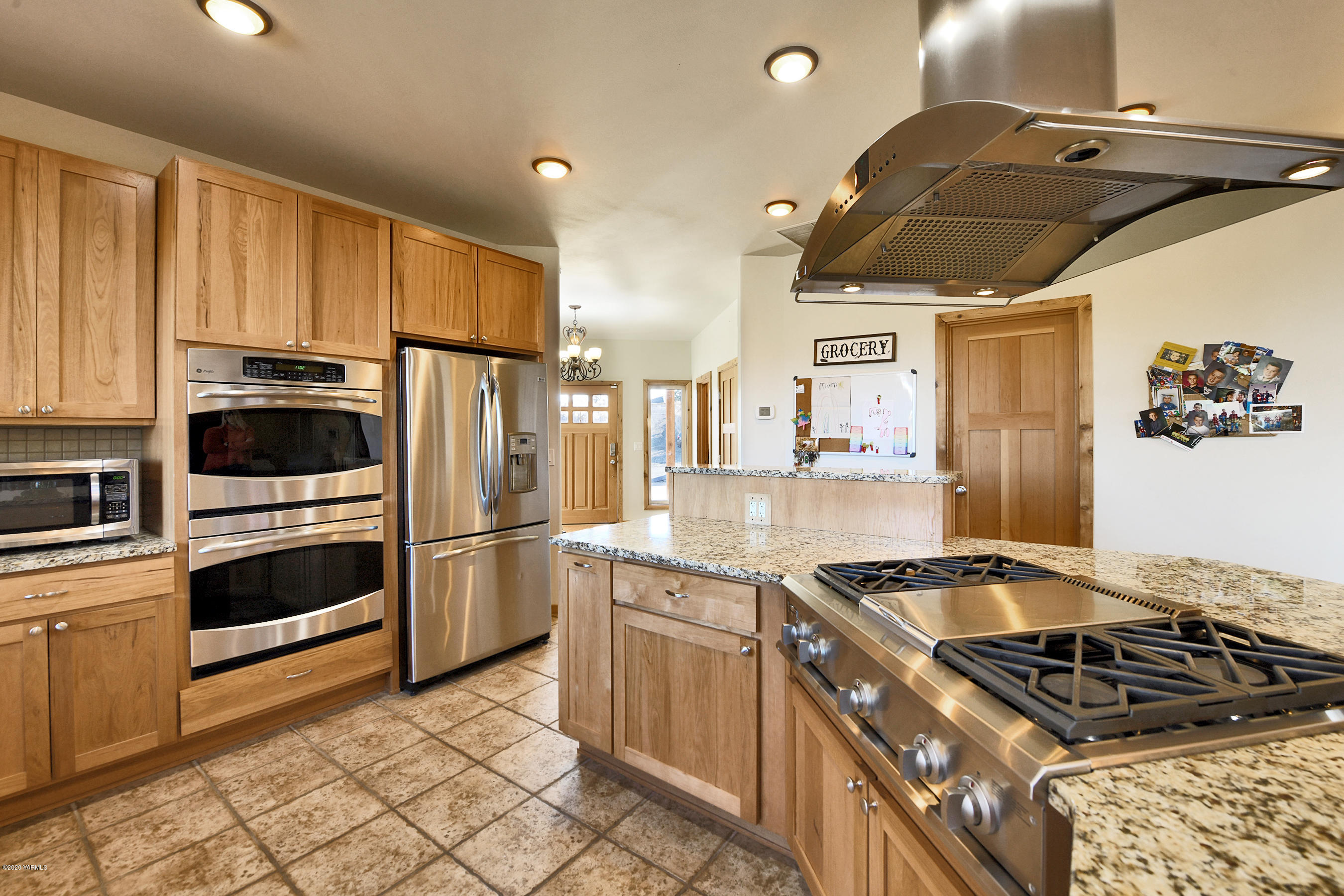 451 Black Hawk Road Yakima, WA 98908 - Photo 4 of 27 a kitchen with granite countertop a stove and a refrigerator