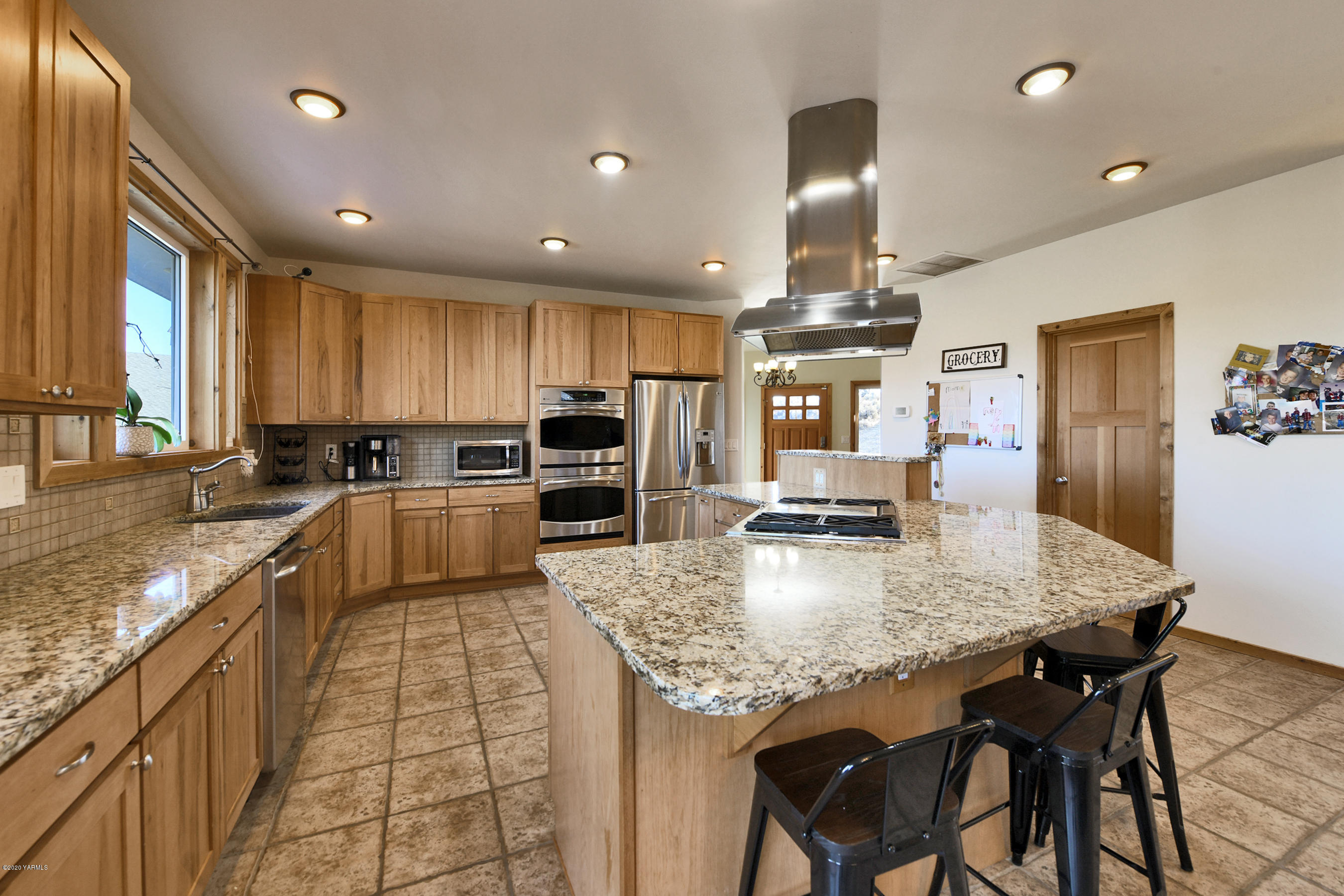 451 Black Hawk Road Yakima, WA 98908 - Photo 5 of 27 a kitchen with granite countertop kitchen island stainless steel appliances a sink stove and refrigerator