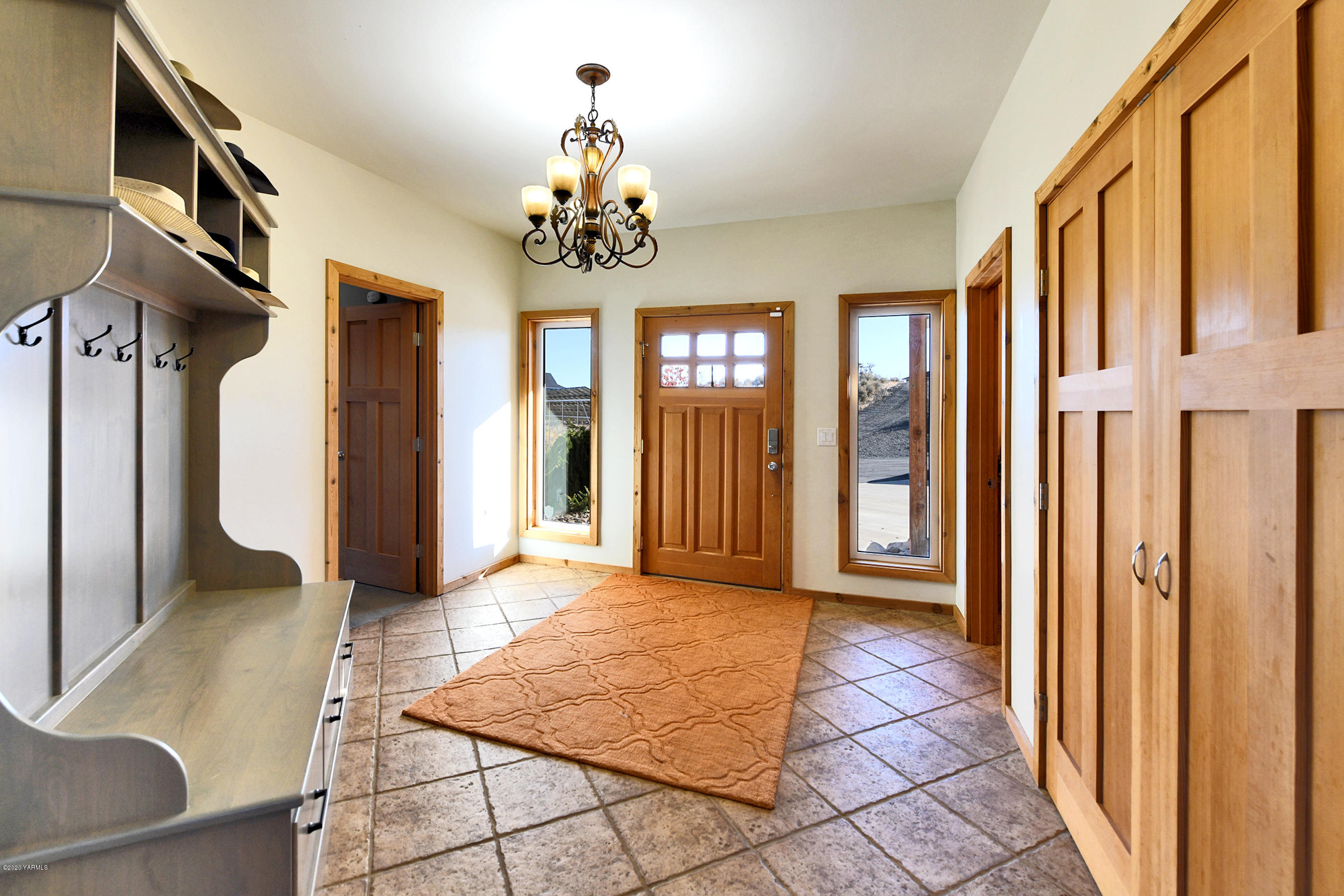 451 Black Hawk Road Yakima, WA 98908 - Photo 7 of 27 a view of a hallway with wooden floor and chandelier