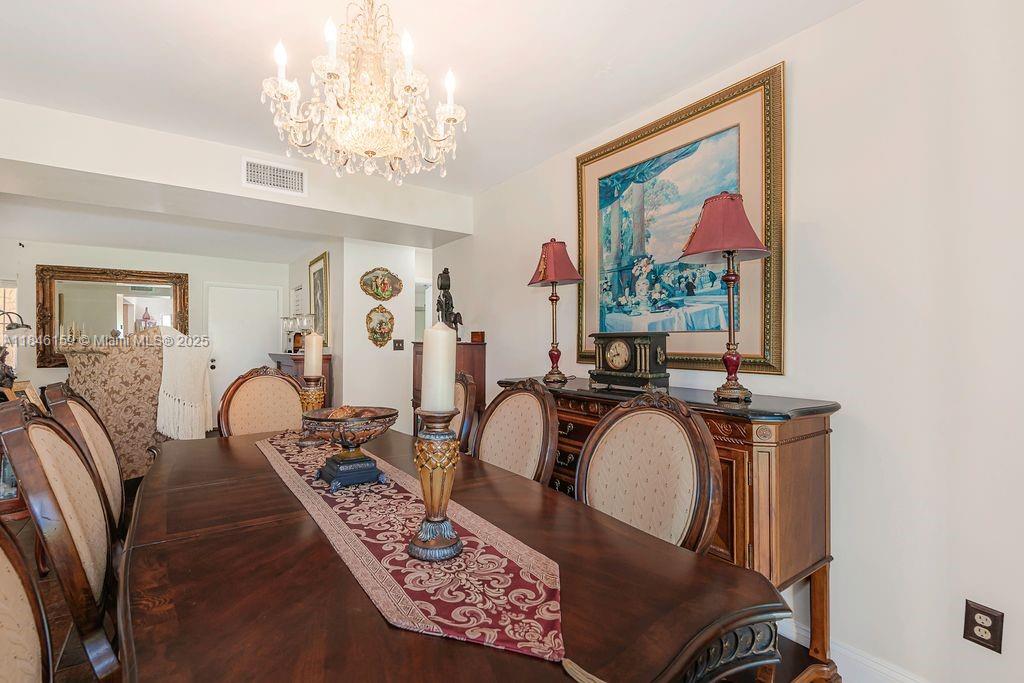 8401 Southwest 107th Avenue, Unit 214E Miami, FL 33173 - Photo 14 of 28 a view of a living room and a chandelier