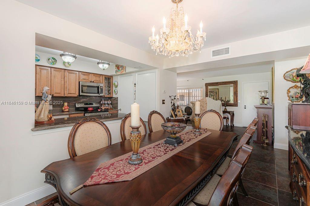 8401 Southwest 107th Avenue, Unit 214E Miami, FL 33173 - Photo 15 of 28 a very nice looking dining room with furniture