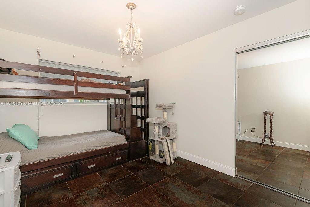 8401 Southwest 107th Avenue, Unit 214E Miami, FL 33173 - Photo 22 of 28 a bedroom with a bed and ceiling fan