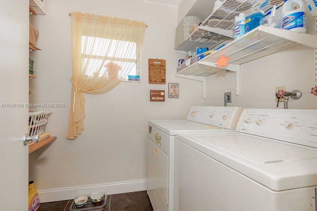 8401 Southwest 107th Avenue, Unit 214E Miami, FL 33173 - Photo 25 of 28 a utility room with dryer and washer