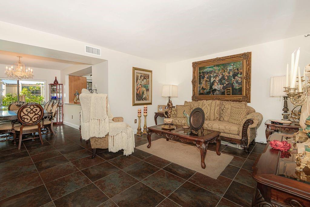 8401 Southwest 107th Avenue, Unit 214E Miami, FL 33173 - Photo 10 of 28 a living room with furniture a couch and a potted plant
