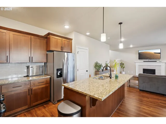 a kitchen with kitchen island a sink stove and refrigerator