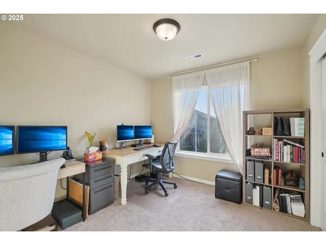 a living room with a couch and a book shelf