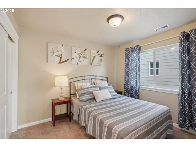 a bedroom with a bed and a night stand